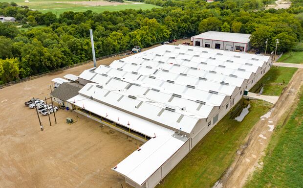 Coating being applied to commercial roof
