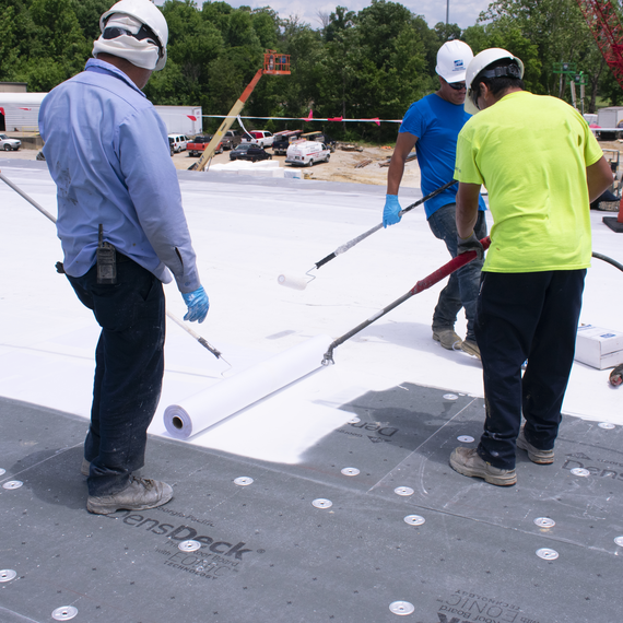 Coating being applied to commercial roof