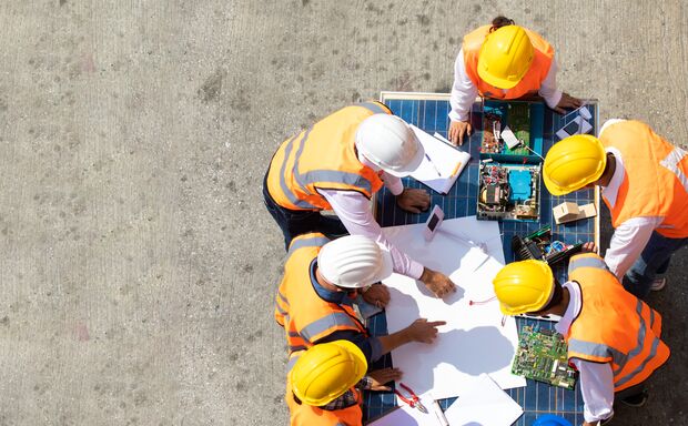 Ethnic diversity worker people, Success teamwork. Group of professional engineering people wearing hardhat safety helmet meeting with solar photovoltaic panels discussion in new project